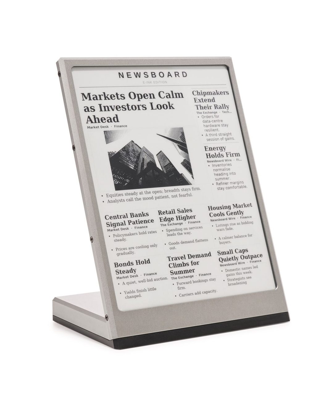 The assembled Newsboard in its natural-silver machined aluminium shell, seen from a three-quarter front angle.